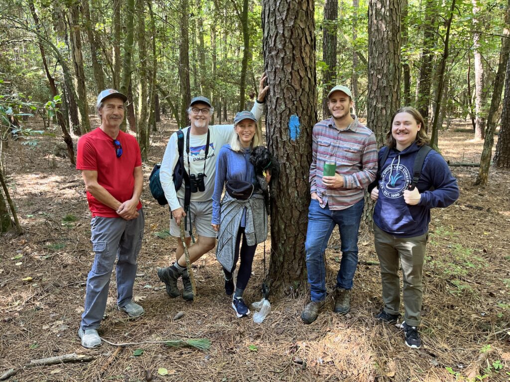 a group of walkers on the trail at mary b. lynch preserve